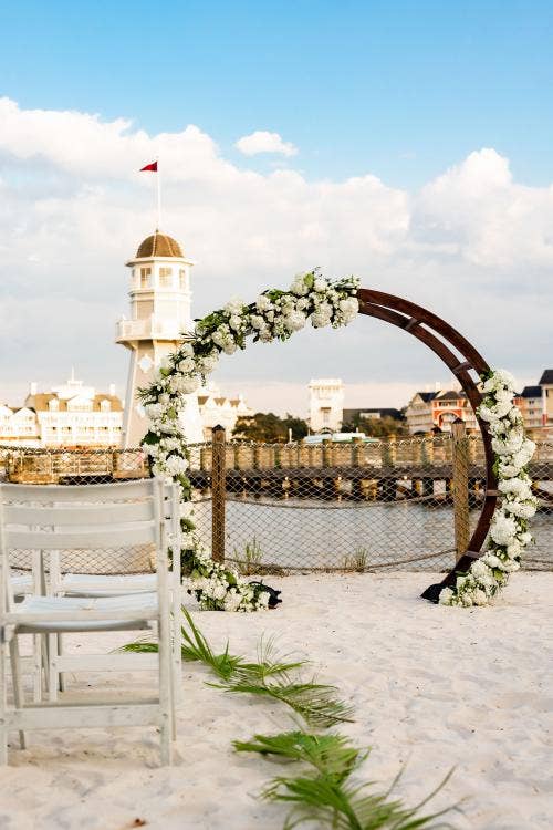 wedding ceremony, ceremony, decorated wedding ceremony, altar area, decorated altar area, palm fronds, altar arch, yacht club, crescent cove, boardwalk, beach, waterfront