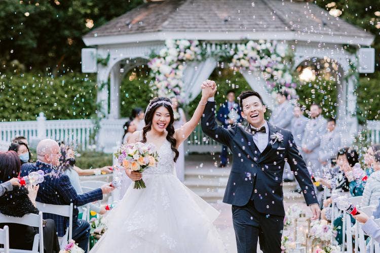 bride and groom, couple, staged exit, exit, wedding ceremony, ceremony, rose court, rose court garden, bubble exit, bubbles, disneyland, Disneyland Hotel