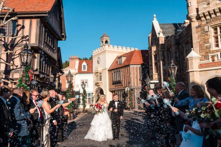 bride and groom, couple, wedding ceremony, ceremony, staged exit, bubble wands, bubbles, bubble exit, Epcot, uk, uk courtyard, uk pavilion, holiday, holiday wedding, holiday decor