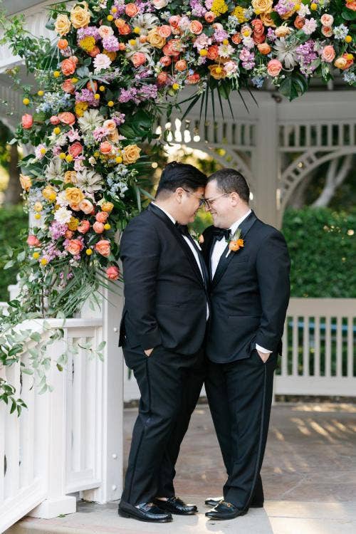 groom groom, lgbtq, lgbtq couple, portrait, couple, disneyland, disneyland hotel, rose court, rose court garden, gazebo, altar area, colorful floral, tropical floral, altar floral, disneyland, disneyland hotel, rose court, rose court garden
