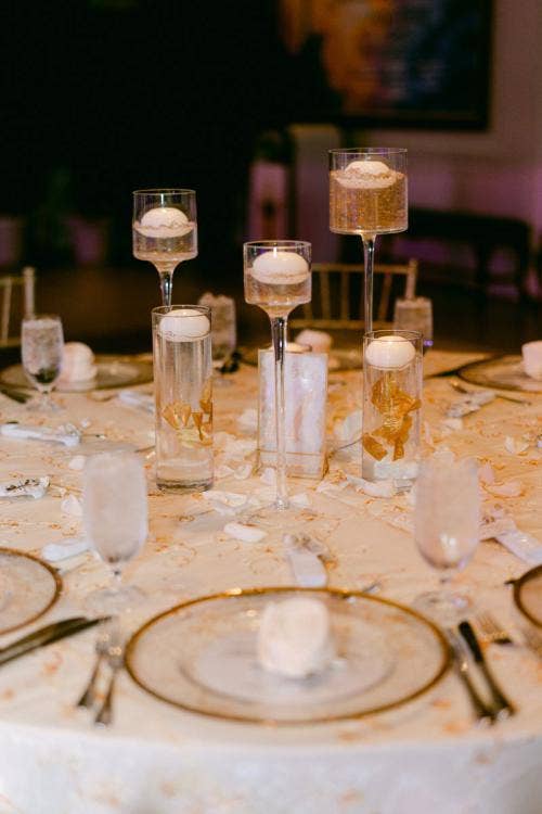 wedding reception, reception, reception tables, centerpieces, floating candles, gold, gold decor, aa rotunda, American adventure rotunda, Epcot, America pavilion