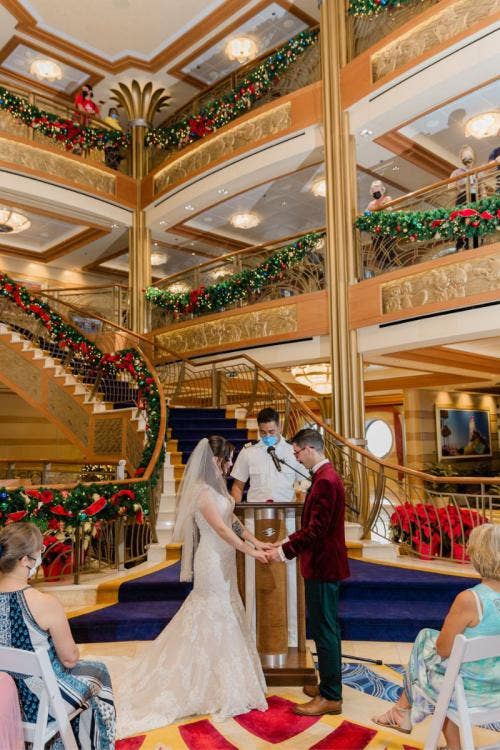 bride and groom, couple, wedding ceremony, ceremony, disney cruise line, cruise line, cruise, disney cruise, cruise wedding, atrium, christmas, christmas wedding, christmas cruise, vows, exchanging vows
