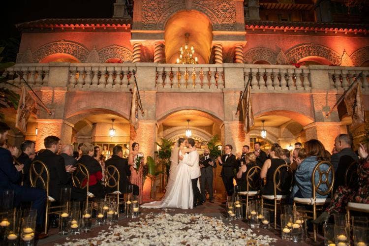 bride and groom, couple, wedding ceremony, ceremony, candid, vows, sharing vows, custom up lighting, up lighting, nighttime, tower of terror, hollywood studios, first kiss, kiss