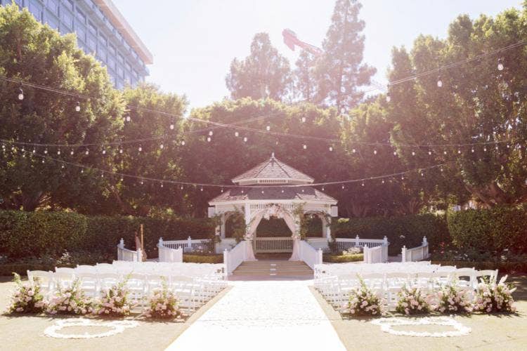 decorated wedding ceremony, ceremony, wedding ceremony, aisle floral, aisle decor, hidden mickeys, mickey floral, hidden mickey floral, boho floral, Disneyland, Disneyland Hotel, rose court, rose court garden