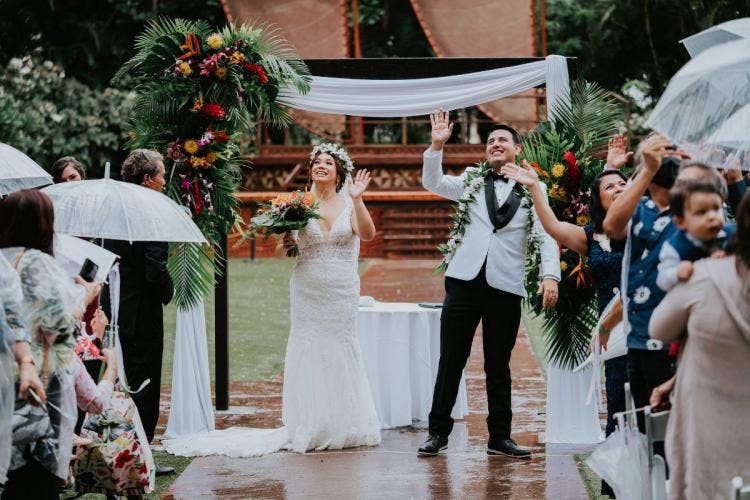 bride and groom, couple, candid, wedding ceremony, ceremony, halawai lawn, halawai, tropical floral, tropical, altar area, altar, altar floral, altar arch, white drape, flower crown, lei