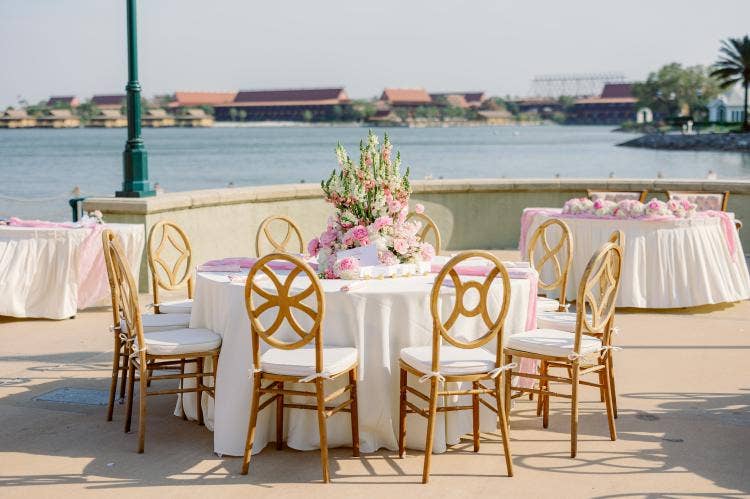 decorated wedding reception, reception, venue, venue shot, custom chairs, floral centerpieces, spring floral, pink floral, summerhouse, summerhouse patio, grand floridian