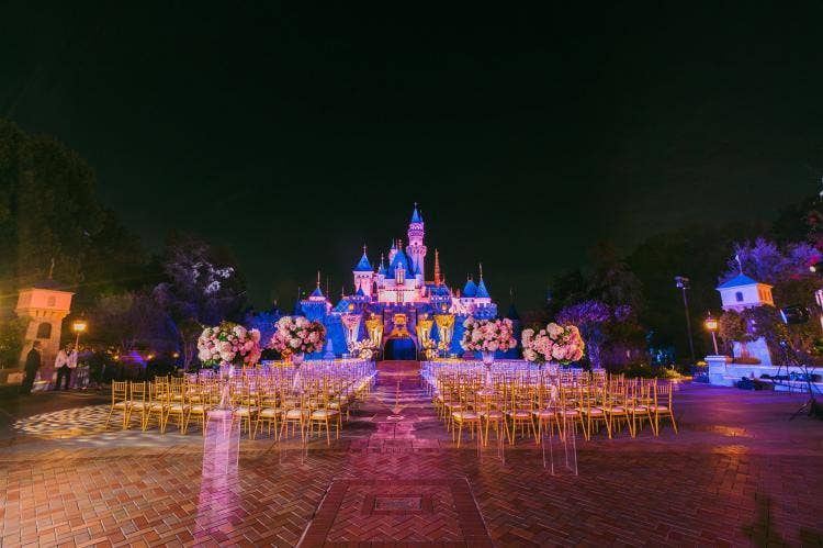 decorated wedding ceremony, wedding ceremony, ceremony, venue, castle, sleeping beauty castle, disneyland, custom chairs, chiavari chairs, gold chairs, floral, bouquets