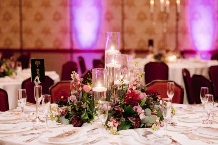 wedding reception, reception, decor, table decor, table centerpieces, floating candles, moody aesthetic, custom up lighting, up lighting, purple up lighting, halloween, halloween theme