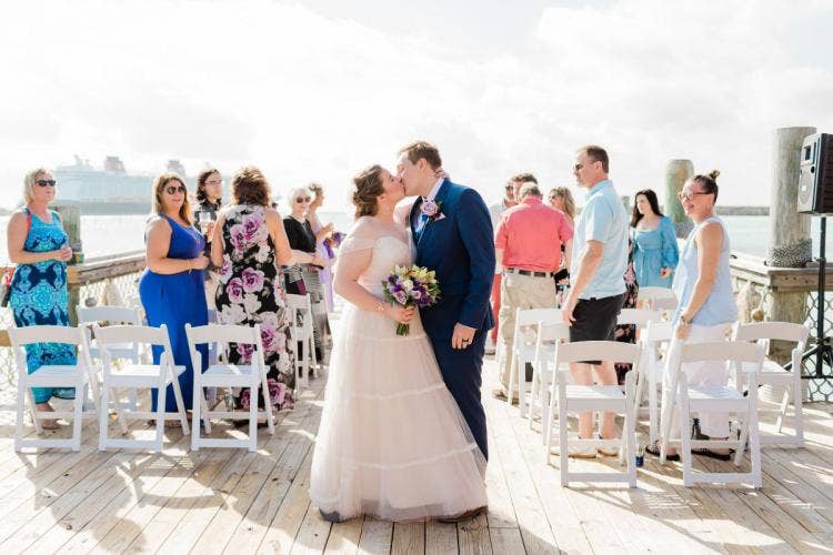 bride and groom, couple, staged exit, exit, wedding ceremony, ceremony, kiss, Disney cruise line, cruise line, cruise, castaway cay, the wedding pointe