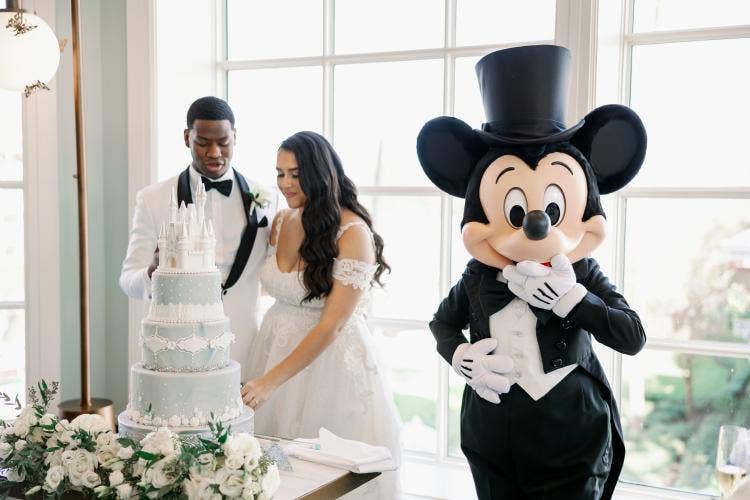 bride and groom, couple, candid, entertainment, character, Mickey Mouse, reception, wedding reception, Disney's grand Floridan resort & spa, grand Floridian, citricos, cutting cake, cake