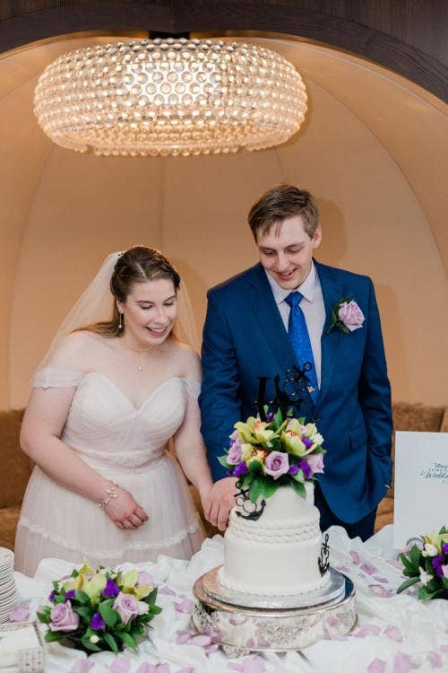 bride and groom, couple, cake cutting, cake, cutting cake, Disney cruise line, cruise line, cruise, cake and champagne, reception celebration