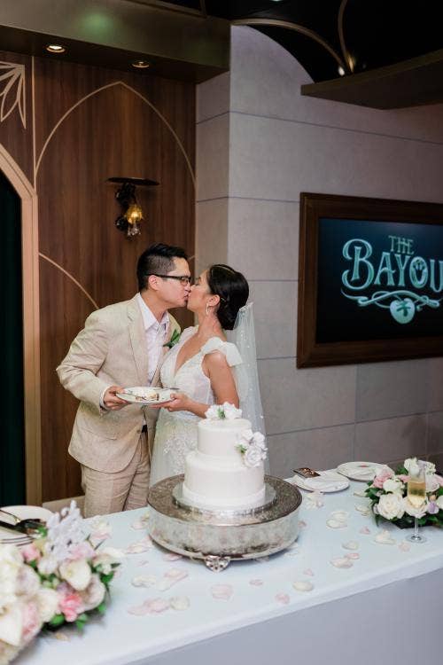 couple, cutting cake, cake, wedding reception, reception, the bayou, bayou, Disney cruise line, cruise wedding, Disney Wish
