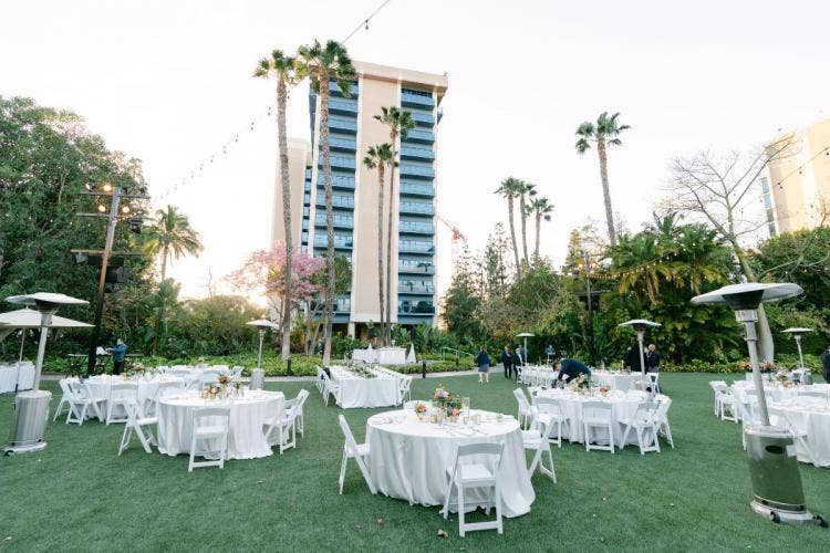 decorated wedding reception, wedding reception, reception, reception decor, reception tables, table rounds, disneyland, disneyland hotel, adventure lawn