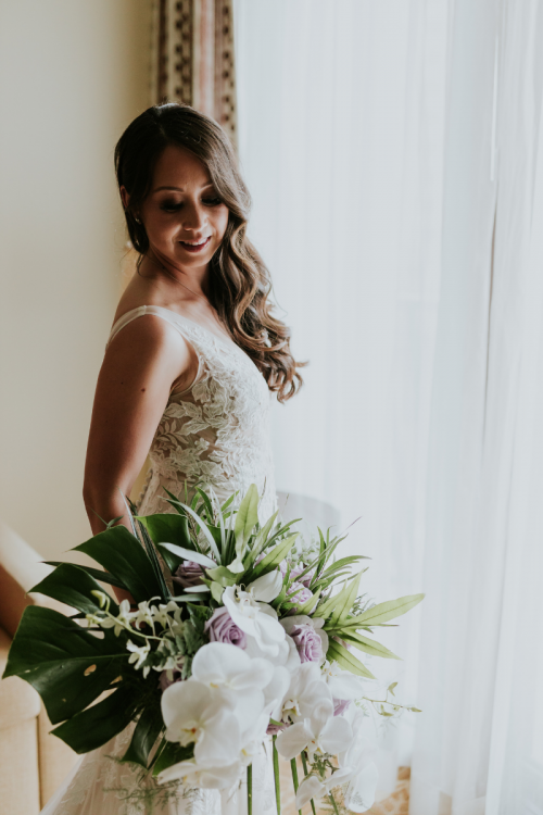 bride, bridal portrait, wedding dress, bridal bouquet, palm fronds, tropical floral, tropical bouquet, getting ready, bride getting ready, hawaii, aulani, aulani wedding, aulani resort, hawaiian wedding