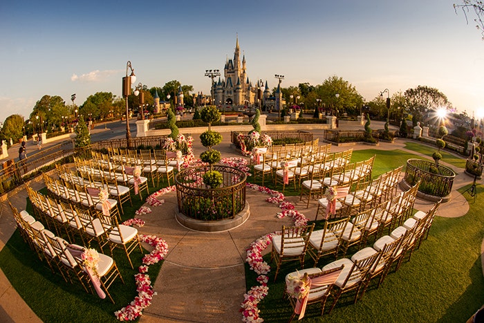 decorated wedding ceremony, wedding ceremony, ceremony, aisle floral, pink floral, custom chairs, chiavari chairs, gold chairs, magic kingdom, castle, east lawn, magic kingdom east lawn, hub, hub grass