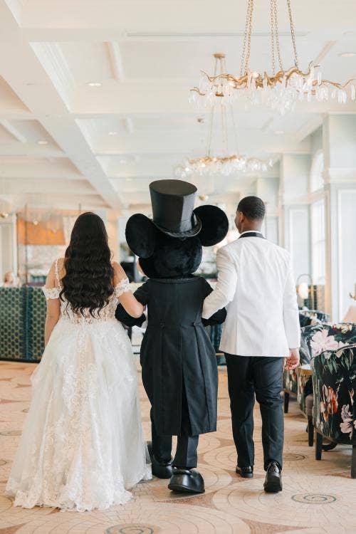 bride and groom, couple, candid, entertainment, character, Mickey Mouse, reception, wedding reception, Disney's grand Floridan resort & spa, grand Floridian, citricos