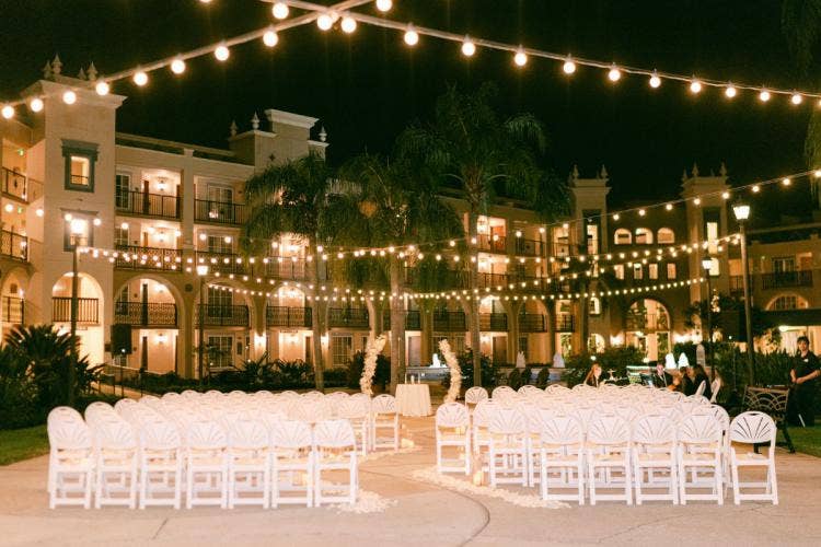 decorated ceremony, wedding ceremony, ceremony, Coronado, Coronado springs, casitas, casitas courtyard, altar floral, altar arch, floral arch, white floral, curved aisle, floral aisle, string lights, candles, aisle candles