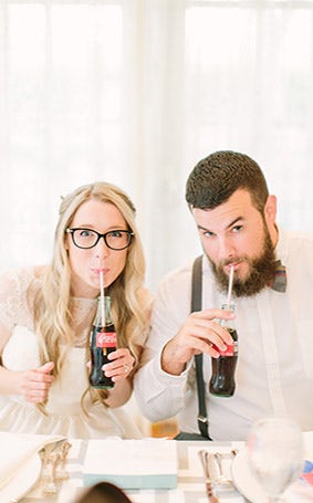 Bride and groom drinking classic Coke