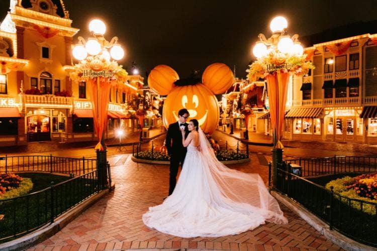 bride and groom, couple, portrait, couple portrait, disneyland, main street, halloween, halloween decor, fall, mickey pumpkin