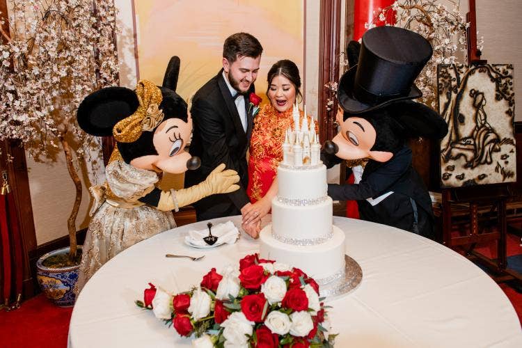 couple, portrait, cutting cake, cake, entertainment, character, Mickey and Minnie, wedding reception, reception, Epcot, china, china pavilion, great hall of china