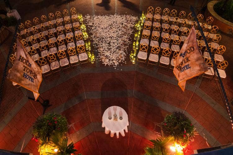 wedding ceremony, ceremony, ceremony decor, venue shot, petal toss, white petal toss, aisle, aisle decor, aisle floral, floating candles, custom chairs, gold chairs, birds eye view, hollywood studios, tower of terror