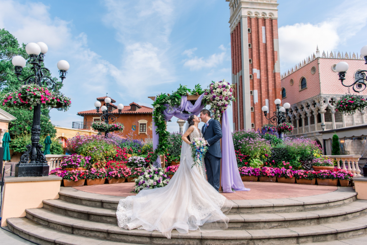 bride and groom, couple, portrait, wedding ceremony, ceremony, altar area, decorated atlar, altar, floral, altar floral, purple, purple floral, purple drape, italy, italy pavilion, epcot, italy plaza