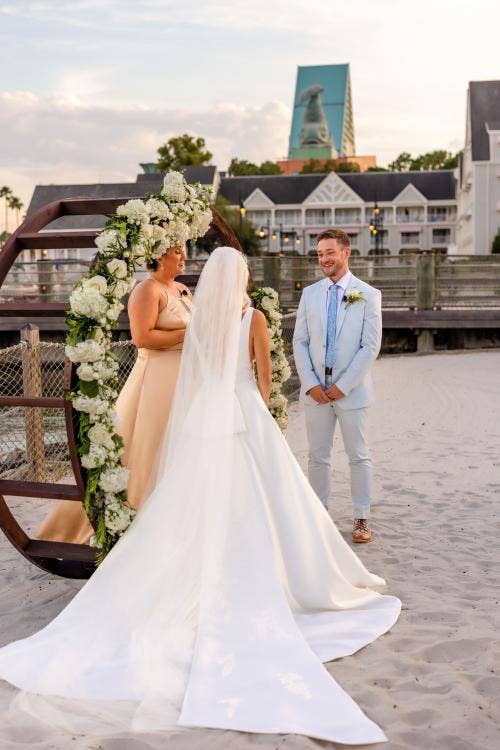 bride and groom, couple, wedding ceremony, ceremony, vows, exchanging vows, yacht and beach club, yacht and beach, crescent cove, beach, waterfront, altar area, altar arch