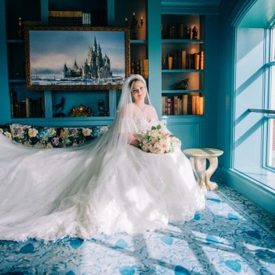 A bride posing in an elegant room at the Disney’s Grand Floridian Resort & Spa at Walt Disney World Resort