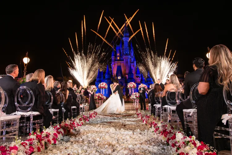 A bride and groom celebrating their first kiss during an After-Hours Ceremony at Magic Kingdom Park