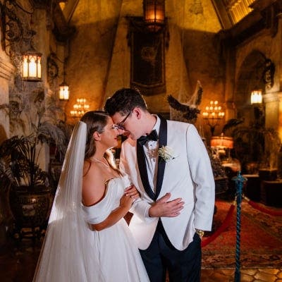 A wedding couple embracing in the lobby of the Twilight Zone Tower of Terror attraction at Disney's Hollywood Studios