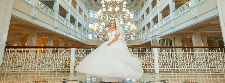 A bride twirling in her wedding gown in the grand lobby of Disney's Grand Floridian Resort & Spa