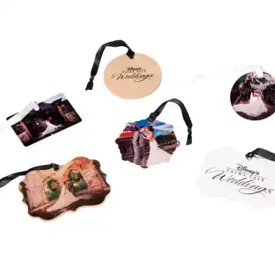 Ornaments of wedding photos and one that reads ‘Disney’s Fairy Tale Weddings,’ with ribbons attached