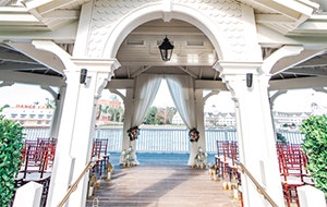 Steps leading up to a large gazebo holding rows of chairs and an altar