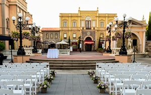 A long aisle leading towards a raised platform in the middle of a courtyard