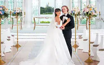 A couple posing at the altar in Disney's Wedding Pavilion