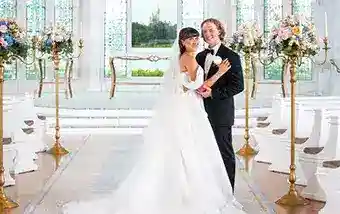 A couple posing at the altar in Disney's Wedding Pavilion