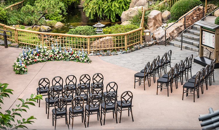 30 chairs arranged in 3 rows for an outdoor wedding beside a koi pond in the Japan Pavilion at EPCOT