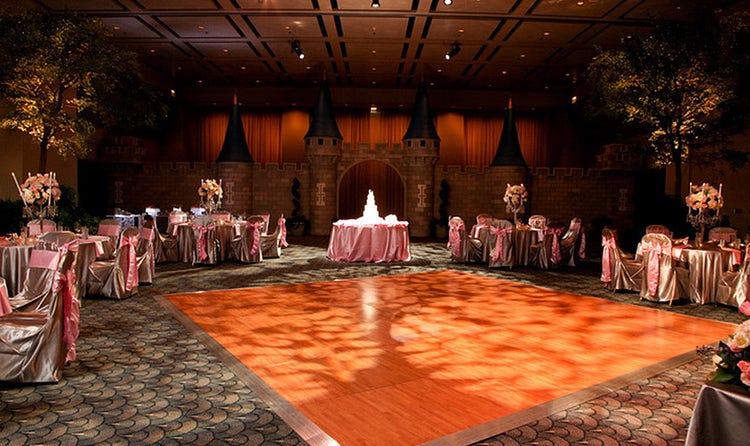 Replica walls of Cinderella Castle surrounding a dance floor in a large ballroom