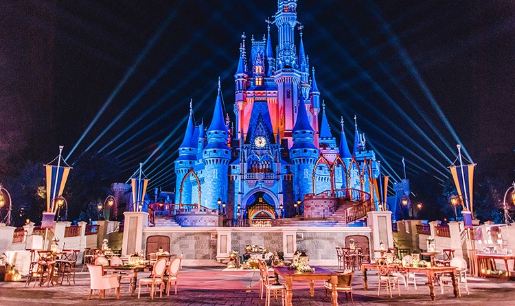 Chairs and tables are set up in front of Cinderella Castle in Magic Kingdom park