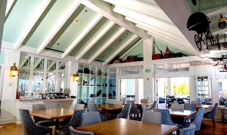 A dining area featuring tables and chairs with a buffet counter in Disney's BoardWalk Inn