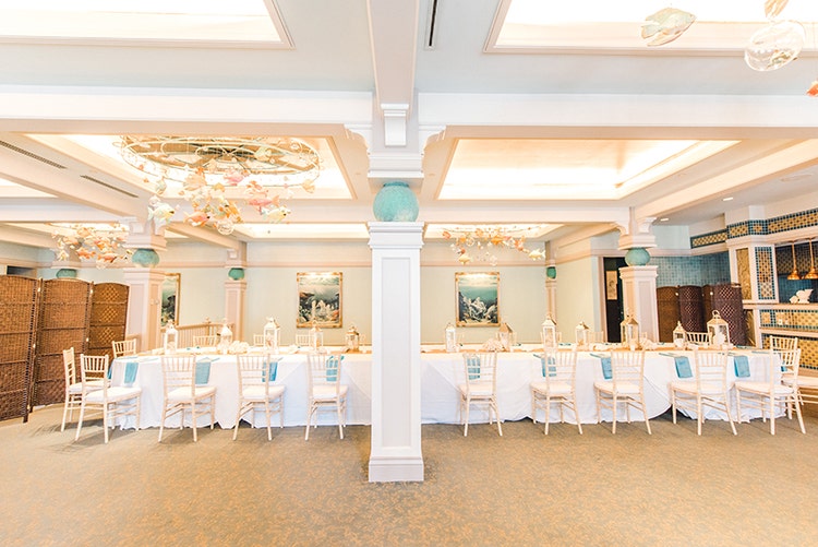 A long table under hanging decorations featuring figures of fish and bubbles