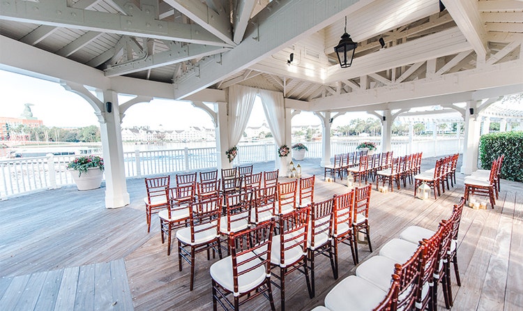 Rows of chairs arranged on a deck overlooking a lake