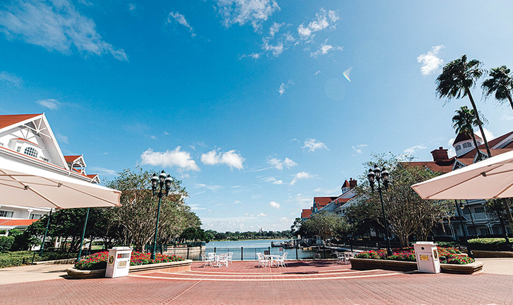 Disney’s Grand Floridian Resort and Spa buildings on both sides of the brick patio that overlooks the marina