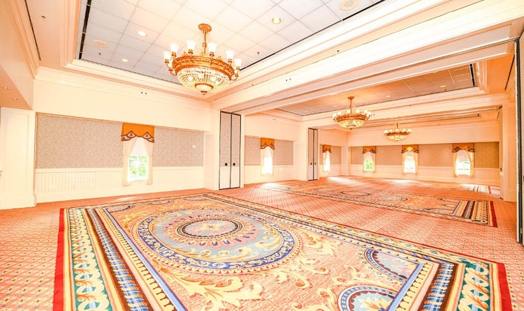 An intimate ballroom at Disney's BoardWalk Inn featuring chandeliers