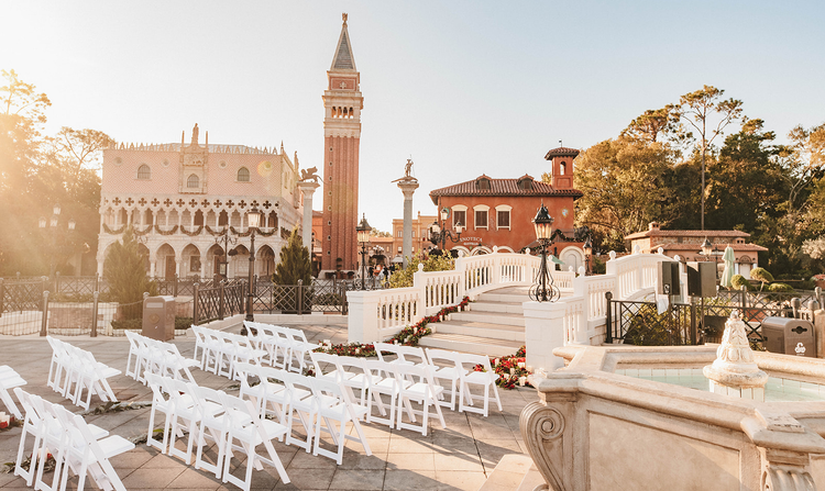 A long table, set for a wedding reception amid the Italian style buildings of Italy Isola in EPCOT at night