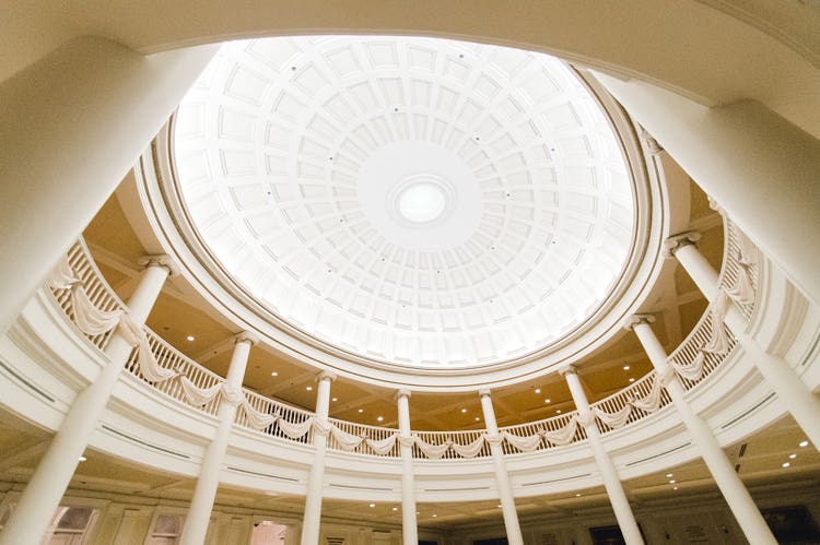 The second floor of the rotunda at The American Adventure in EPCOT featuring high ceilings and pillars