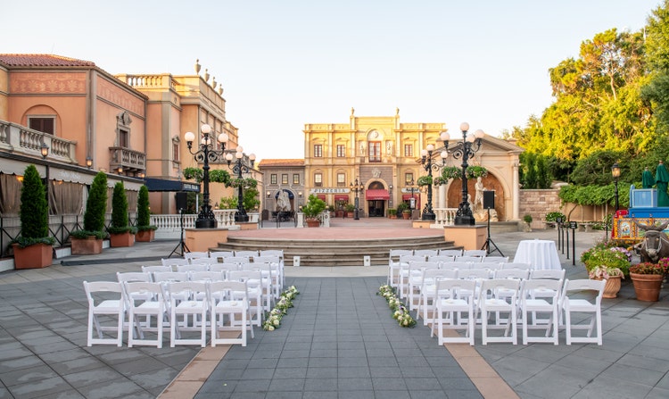 Rows of outdoor seating for a wedding ceremony in the Italy Plaza at Epcot