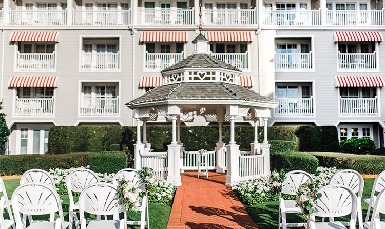 Two rows of chairs face an altar under a gazebo