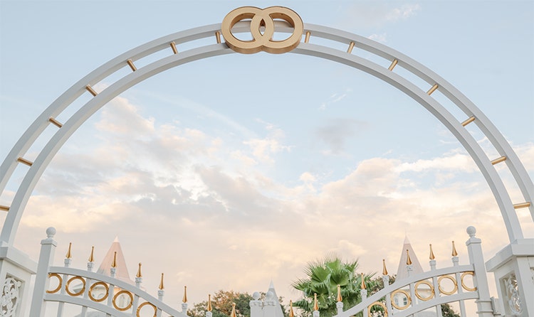 A symbol at the top of the front gate of Disney’s Wedding Pavilion features 2 linked rings