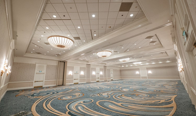 A large ballroom with ornate chandeliers at Disney's Grand Floridian Convention Center